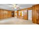 View of the living room and kitchen featuring wood paneled walls and neutral carpet at 304 Simrill Ave, York, SC 29745