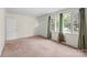 Bright living room with carpet, multiple windows, and a view of the outdoors, creating a welcoming space at 304 Simrill Ave, York, SC 29745