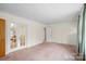 Open living room with carpet, French doors, and neutral wall color, providing a flexible living space at 304 Simrill Ave, York, SC 29745