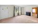 Cozy living room featuring a fireplace, large windows with curtains, and carpeted flooring at 304 Simrill Ave, York, SC 29745