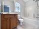 This bathroom includes vanity storage and a shower/tub combo with a window view at 3155 Golden Dale Ln, Charlotte, NC 28262