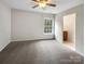This bedroom has a ceiling fan, carpeted floor, and an ensuite bathroom at 3155 Golden Dale Ln, Charlotte, NC 28262