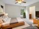 Bright bedroom with a ceiling fan, carpeted floor, and an ensuite bathroom at 3155 Golden Dale Ln, Charlotte, NC 28262