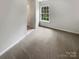 Bedroom with neutral walls and carpet features a window at 3155 Golden Dale Ln, Charlotte, NC 28262