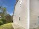 Exterior side view of the home with vinyl siding and a well-maintained lawn at 3155 Golden Dale Ln, Charlotte, NC 28262