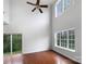Spacious living room with tall ceilings, hardwood floors, and sliding doors to the backyard at 3155 Golden Dale Ln, Charlotte, NC 28262