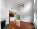 The living room is very spacious, features hardwood floors and a fireplace with adjacent kitchen at 3155 Golden Dale Ln, Charlotte, NC 28262