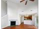Bright living room featuring a fireplace and hardwood floors, open to the kitchen at 3155 Golden Dale Ln, Charlotte, NC 28262