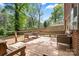 Wood back deck with bench seating, wicker chairs, and wooded views at 3612 Winterfield Pl, Charlotte, NC 28205