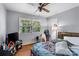 Cozy bedroom with ceiling fan, hardwood floors, natural light, and a closet for storage at 3612 Winterfield Pl, Charlotte, NC 28205