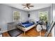 Bright bedroom featuring hardwood floors, two windows for natural light, and a ceiling fan at 3612 Winterfield Pl, Charlotte, NC 28205
