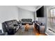Comfortable living room boasts hardwood floors, a large sectional sofa, and a mounted television for relaxing evenings at 3612 Winterfield Pl, Charlotte, NC 28205