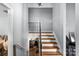 Stairway leading to the second level with wood stairs, ornamental metal railing, and neutral wall paint at 3612 Winterfield Pl, Charlotte, NC 28205