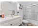 Bright bathroom featuring a white vanity, tiled shower and glass doors, complemented by modern fixtures and ample storage at 4020 Brandie Glen Rd, Charlotte, NC 28269