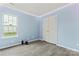 Inviting bedroom with neutral walls, modern floors, ample natural light from a window, and a closet at 4020 Brandie Glen Rd, Charlotte, NC 28269