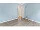 Airy bedroom featuring modern floors, neutral walls, with light and a view through an open doorway at 4020 Brandie Glen Rd, Charlotte, NC 28269