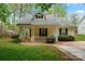 Inviting single-story home with a classic covered front porch and manicured shrubs at 4020 Brandie Glen Rd, Charlotte, NC 28269
