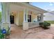Inviting covered front porch with classic columns and cozy seating area at 4020 Brandie Glen Rd, Charlotte, NC 28269