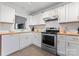 Bright kitchen features white cabinets, stainless steel appliances, butcher block countertops, and subway tile backsplash at 4020 Brandie Glen Rd, Charlotte, NC 28269