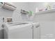 Functional laundry area with modern appliances, practical shelving, and utility connections at 4020 Brandie Glen Rd, Charlotte, NC 28269