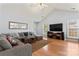 Bright living room with large sectional sofa, TV, and hardwood floors at 4020 Brandie Glen Rd, Charlotte, NC 28269