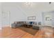 Spacious living room featuring hardwood floors, vaulted ceilings, ample seating, and natural light at 4020 Brandie Glen Rd, Charlotte, NC 28269