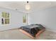 Serene main bedroom with tray ceiling, a modern light fixture, and lots of natural light from multiple windows at 4020 Brandie Glen Rd, Charlotte, NC 28269