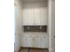 Convenient butler pantry features sleek white cabinetry, quartz countertops, and a stylish backsplash at 4126 Eastover Glen Rd # 0317, Charlotte, NC 28269
