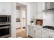 Well-lit modern kitchen with white cabinets, stainless steel appliances, and stylish backsplash at 4126 Eastover Glen Rd # 0317, Charlotte, NC 28269