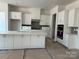 Bright, modern kitchen featuring white cabinets, stainless steel appliances, and a large center island with quartz countertops at 4126 Eastover Glen Rd # 0317, Charlotte, NC 28269