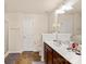 Bright bathroom featuring a double sink vanity, shower, toilet and tile flooring at 4528 Craigmoss Ln, Charlotte, NC 28278