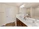 Bright bathroom featuring double sinks, granite counters, tile flooring, vanity and decorative mirror at 4528 Craigmoss Ln, Charlotte, NC 28278