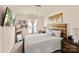 This well-lit bedroom has a decorative wall mirror and a mounted television at 4528 Craigmoss Ln, Charlotte, NC 28278