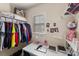 This closet has an open shelving with a clothing rack and a small desk area by the window at 4528 Craigmoss Ln, Charlotte, NC 28278