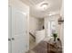 Upstairs hallway with doors leading to bedrooms, decorative accents and carpeted floors at 4528 Craigmoss Ln, Charlotte, NC 28278