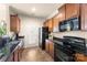 Spacious kitchen with granite countertops, black appliances, wood cabinets and tile flooring at 4528 Craigmoss Ln, Charlotte, NC 28278
