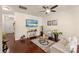 Cozy living room featuring hardwood flooring, a ceiling fan, and modern furnishings at 4528 Craigmoss Ln, Charlotte, NC 28278