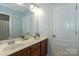 Bathroom featuring double sinks, generous counter space, and white cabinets at 4924 Riverdale Dr, Charlotte, NC 28273