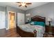 Comfortable bedroom featuring a wooden bed frame, ceiling fan, and ensuite bathroom at 4924 Riverdale Dr, Charlotte, NC 28273