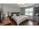 Comfortable bedroom featuring neutral paint, a stylish chandelier, wood floors, and plentiful natural light at 4924 Riverdale Dr, Charlotte, NC 28273