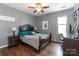 Comfortable bedroom with hardwood floors, a large bed, and ample natural light from a nearby window at 4924 Riverdale Dr, Charlotte, NC 28273