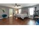 Well-lit bedroom with dark wood floors, lots of windows, and ensuite bathroom access at 4924 Riverdale Dr, Charlotte, NC 28273