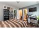Bedroom with laminate floors, a doorway to the bathroom, shelves, and a work space at 4924 Riverdale Dr, Charlotte, NC 28273