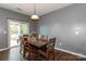 Cozy dining area featuring a rustic wooden table and a sliding glass door to outdoor patio at 4924 Riverdale Dr, Charlotte, NC 28273