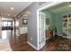 Welcoming entryway featuring hardwood floors, arched doorways, and access to a study with a stylish bookshelf at 4924 Riverdale Dr, Charlotte, NC 28273