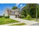 Spacious two-story home with a large front yard, two-car garage, and a well-maintained lawn at 4924 Riverdale Dr, Charlotte, NC 28273