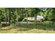 Home exterior features a fenced yard with mature trees, offering privacy and a serene setting at 4924 Riverdale Dr, Charlotte, NC 28273