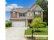 Charming two-story home featuring a brick facade, well-manicured lawn, and attached two-car garage at 4924 Riverdale Dr, Charlotte, NC 28273