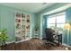 Bright home office with large window, modern desk, hardwood floors, and built-in bookshelf at 4924 Riverdale Dr, Charlotte, NC 28273