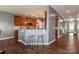 Open kitchen with bar seating, wooden cabinets, granite countertops, and stainless steel appliances at 4924 Riverdale Dr, Charlotte, NC 28273